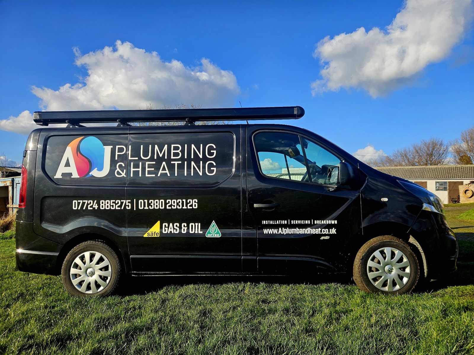 The black AJ Plumbing & Heating van, lettered Gas & Oil