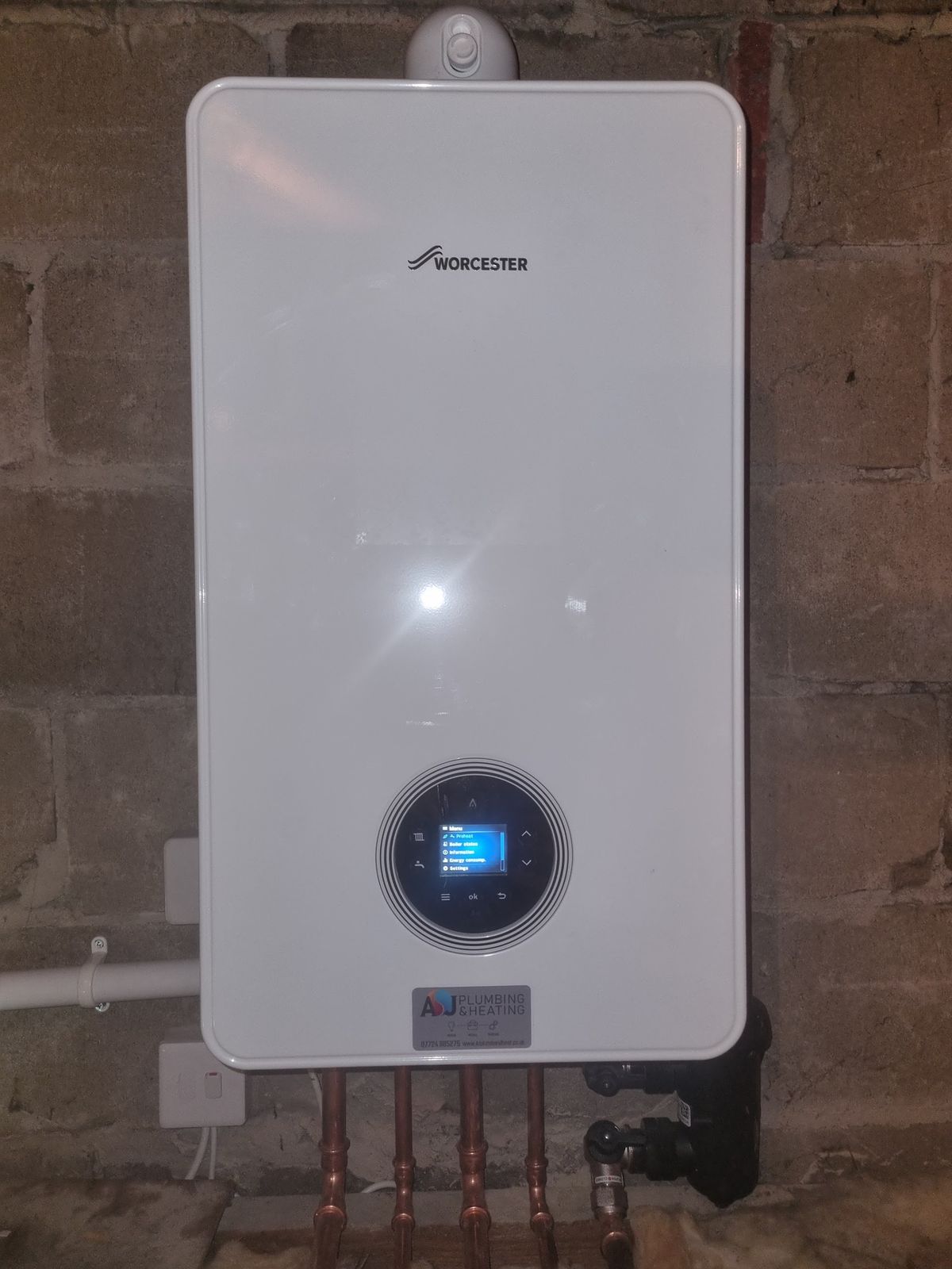 A newly fitted boiler on a brick wall