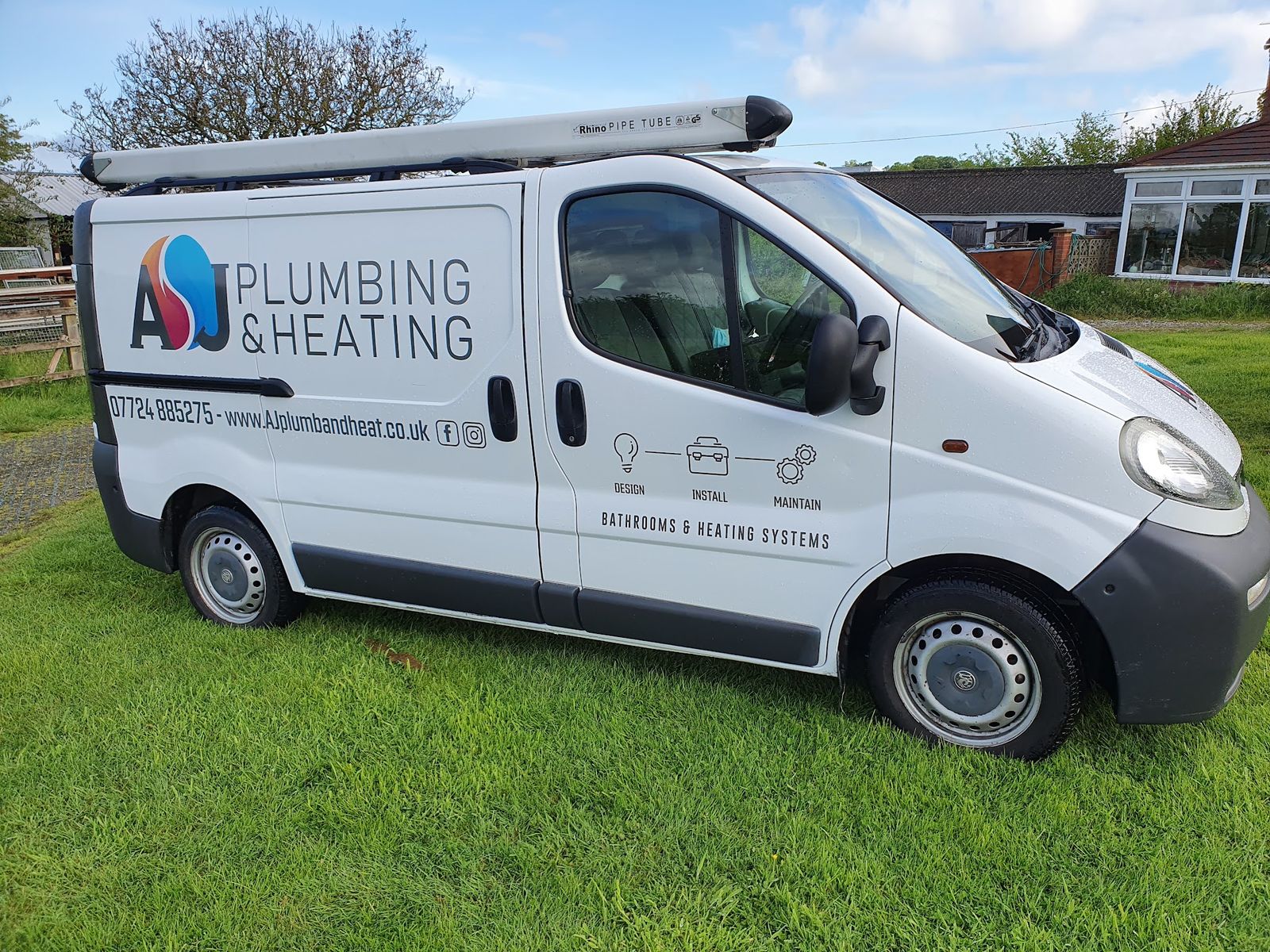 The white AJ Plumbing & Heating van with Design, Install, Maintain on its side